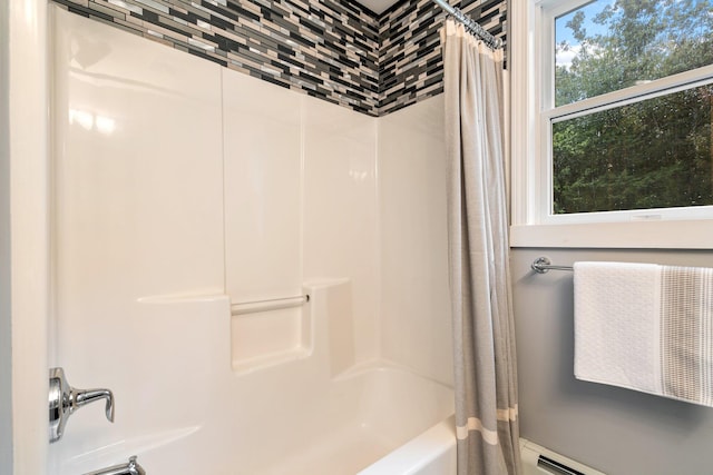 bathroom featuring shower / bathtub combination with curtain and a baseboard radiator