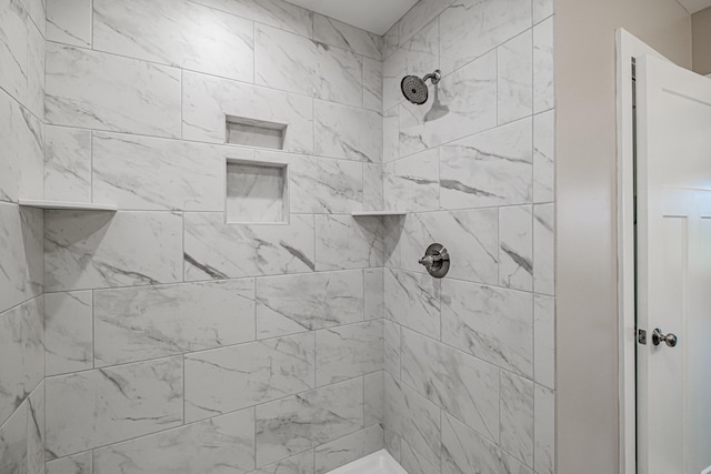 bathroom with a tile shower