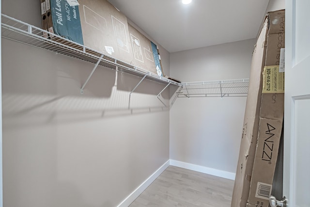 spacious closet featuring light hardwood / wood-style flooring