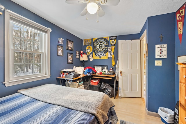 bedroom with ceiling fan and light wood-type flooring