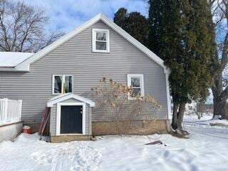 view of snow covered rear of property