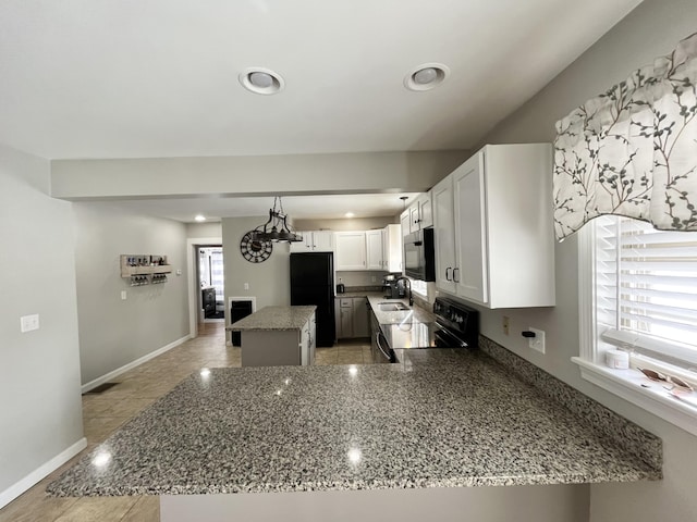 kitchen with a kitchen island, black appliances, white cabinetry, sink, and kitchen peninsula