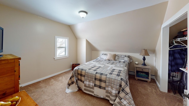 carpeted bedroom with baseboard heating and lofted ceiling