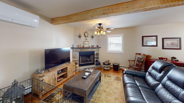 living room with a wall mounted air conditioner, a fireplace, beamed ceiling, hardwood / wood-style flooring, and ceiling fan