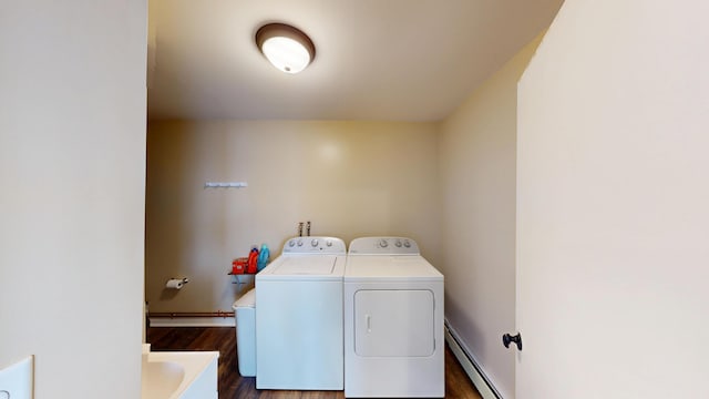 laundry room with sink, dark wood-type flooring, washer and clothes dryer, and a baseboard heating unit