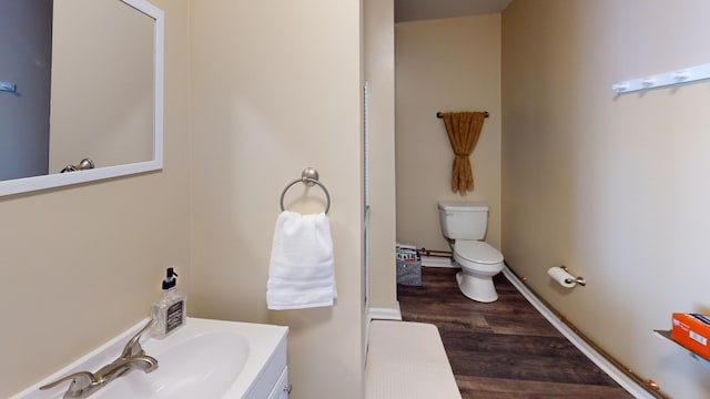 bathroom with sink, hardwood / wood-style floors, and toilet