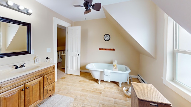 bathroom with ceiling fan, hardwood / wood-style floors, vanity, a bath, and a baseboard radiator