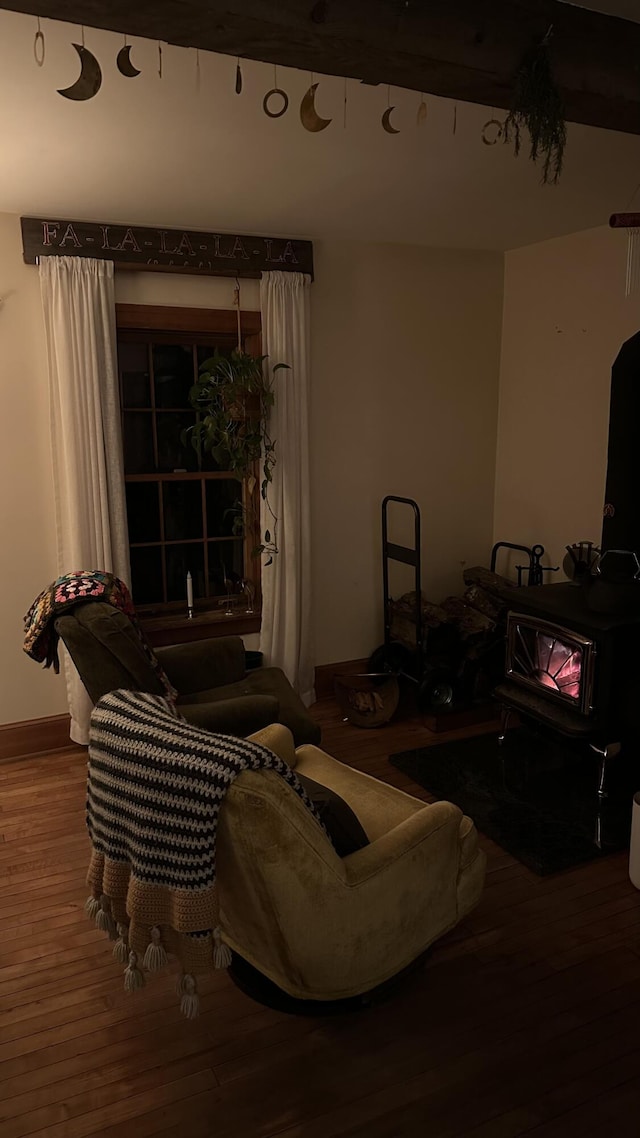 living room featuring hardwood / wood-style floors and a wood stove