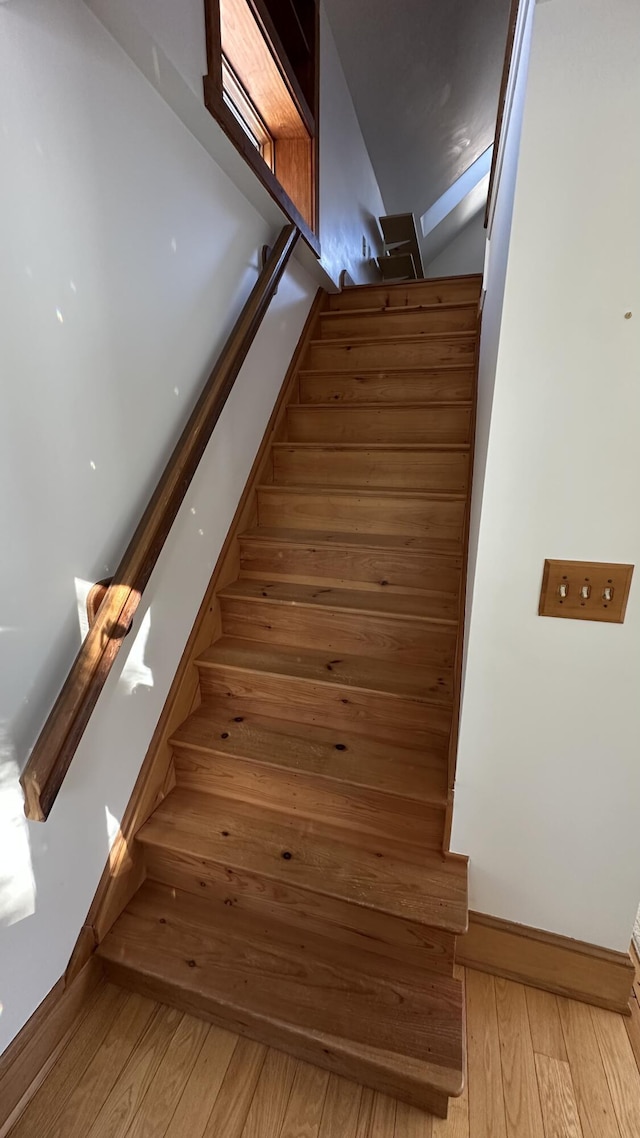 stairway featuring wood-type flooring