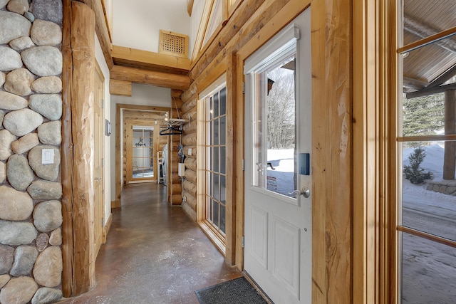 doorway with plenty of natural light and rustic walls