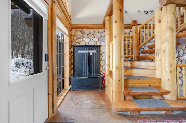 entryway with log walls and a wealth of natural light