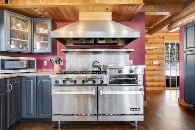 kitchen featuring wood ceiling, island range hood, rustic walls, and appliances with stainless steel finishes