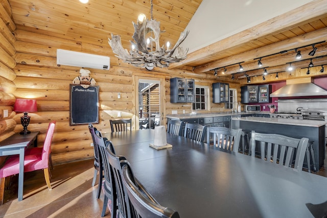 dining area featuring rail lighting, wood ceiling, a chandelier, an AC wall unit, and log walls