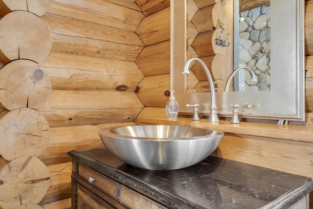 interior details featuring vanity and rustic walls