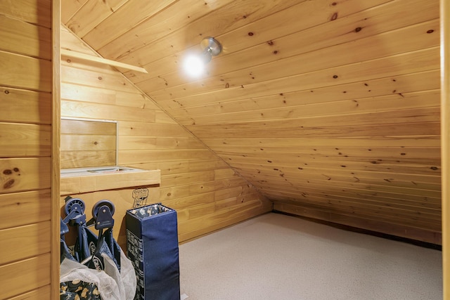 additional living space with wooden walls, wooden ceiling, and vaulted ceiling