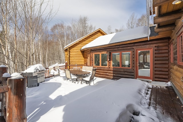 snow covered patio with area for grilling