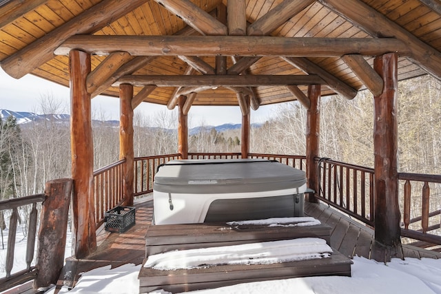 snow covered deck featuring a mountain view