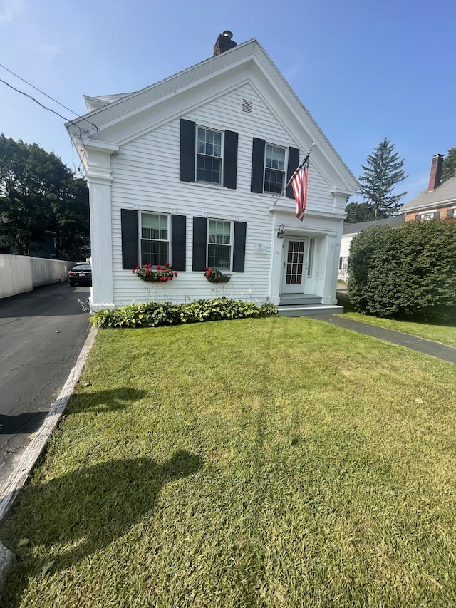 greek revival inspired property with a front lawn