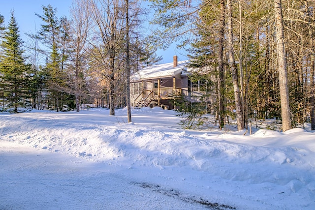 snowy yard with a wooden deck