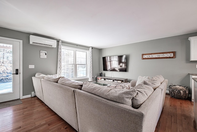 living room with a baseboard radiator, plenty of natural light, a wall mounted air conditioner, and dark hardwood / wood-style flooring