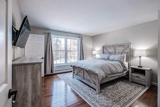 bedroom with dark wood-type flooring and a baseboard radiator