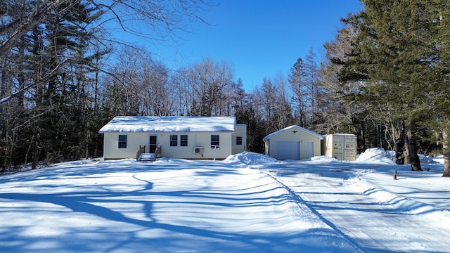 view of front of home featuring an outbuilding, a shed, and a detached garage