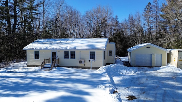 view of front facade with an outdoor structure and a detached garage