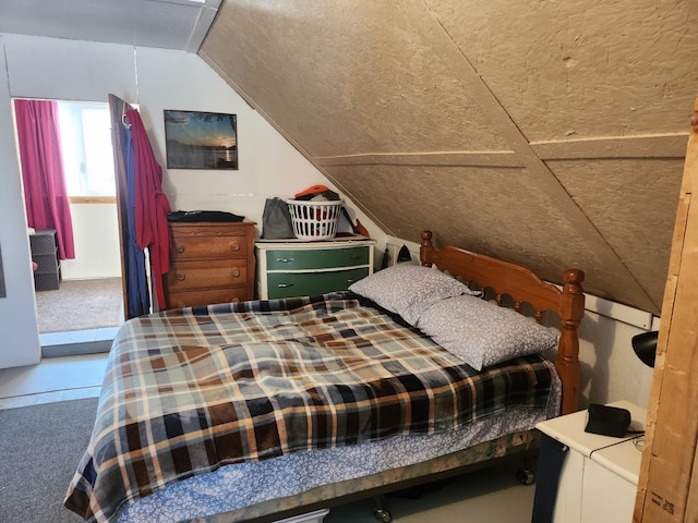 carpeted bedroom featuring lofted ceiling