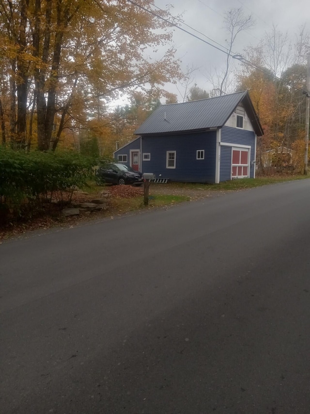 exterior space with a garage and an outdoor structure