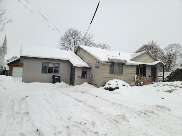 view of snow covered rear of property