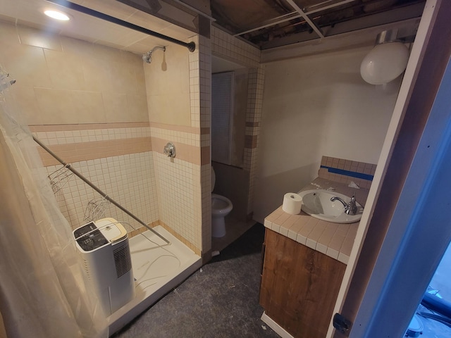 bathroom with a stall shower and vanity