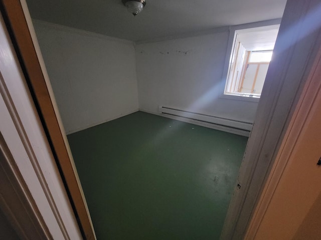 unfurnished room with a baseboard radiator