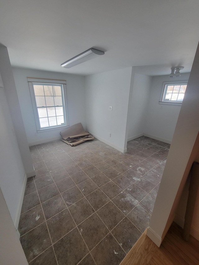 spare room featuring baseboards