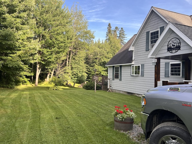 view of home's exterior with a yard and a deck