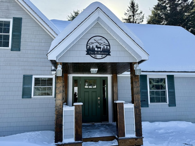 view of snow covered property entrance