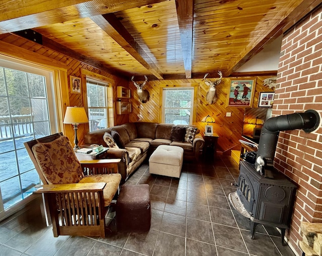 tiled living room featuring wood ceiling, wood walls, beam ceiling, and a wood stove