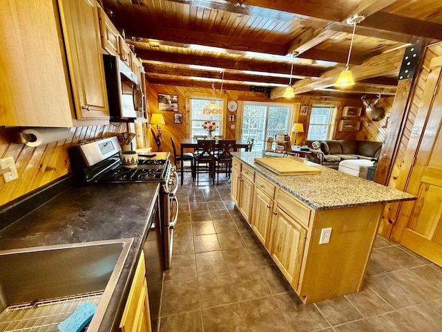 kitchen with appliances with stainless steel finishes, wooden walls, decorative light fixtures, a center island, and wooden ceiling