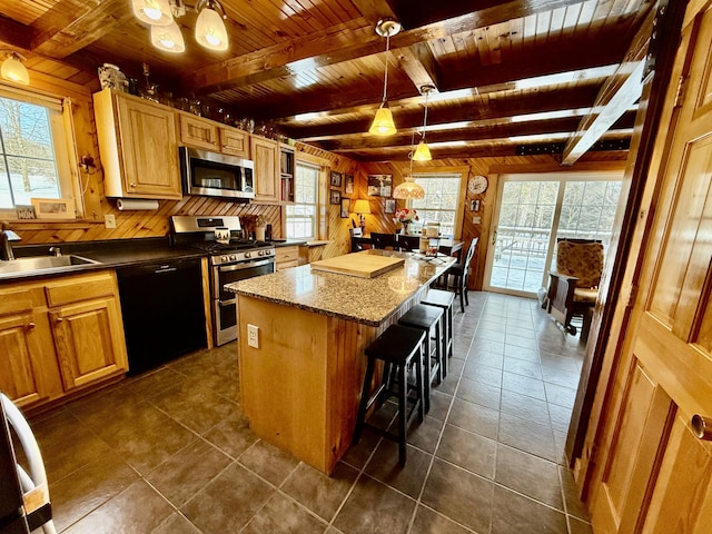 kitchen with appliances with stainless steel finishes, a breakfast bar, hanging light fixtures, a center island, and wood ceiling