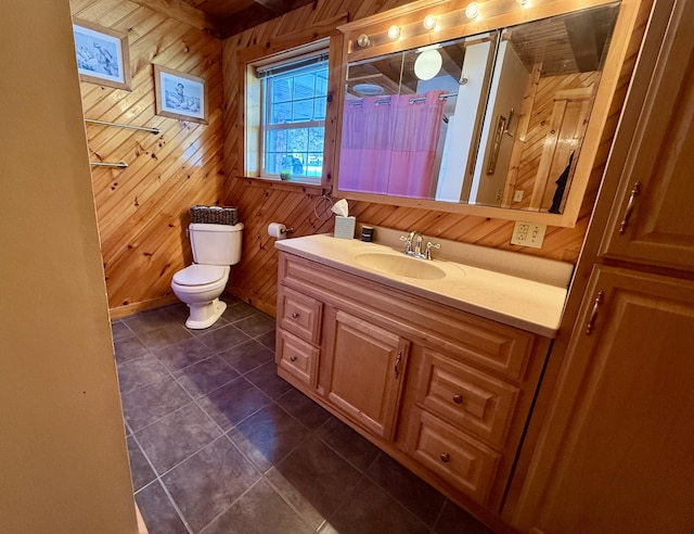 bathroom with vanity, tile patterned flooring, toilet, and wood walls