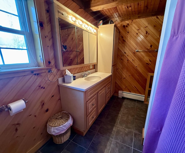 bathroom featuring baseboard heating, vanity, wooden ceiling, tile patterned floors, and wood walls