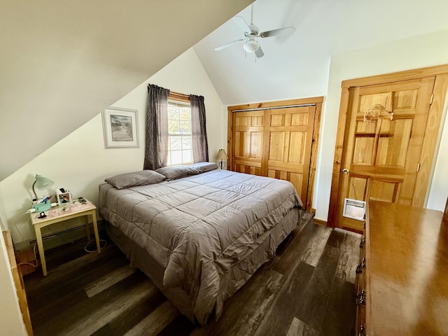 bedroom with vaulted ceiling, dark hardwood / wood-style floors, ceiling fan, and a closet