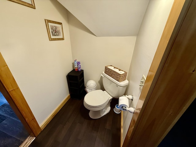 bathroom featuring lofted ceiling, hardwood / wood-style floors, and toilet