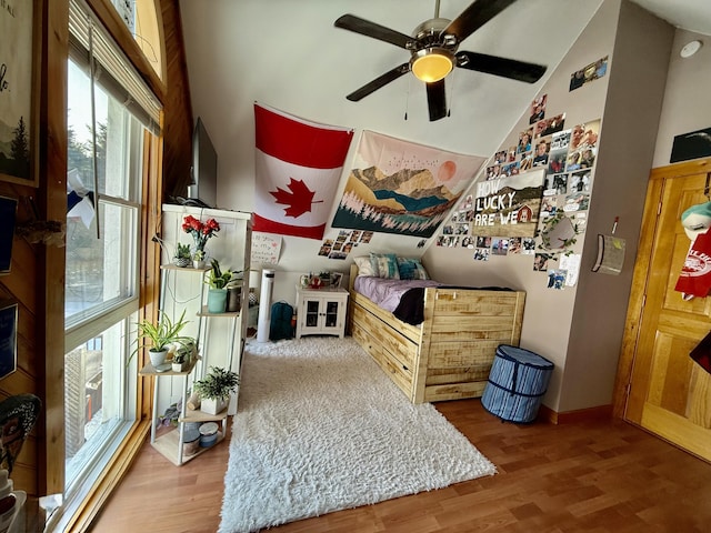 interior space with wood-type flooring, lofted ceiling, and ceiling fan