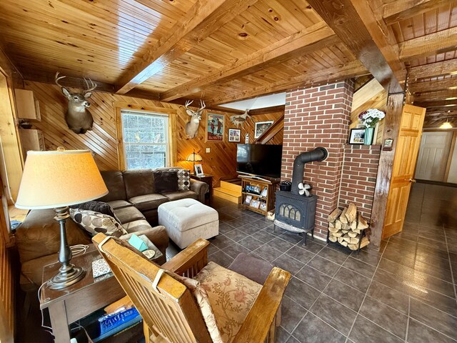 tiled living room featuring beamed ceiling, wood ceiling, a wood stove, and wood walls