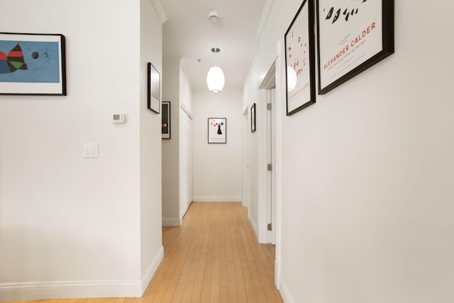 corridor with light hardwood / wood-style floors