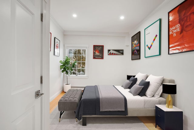 bedroom featuring hardwood / wood-style floors and ornamental molding