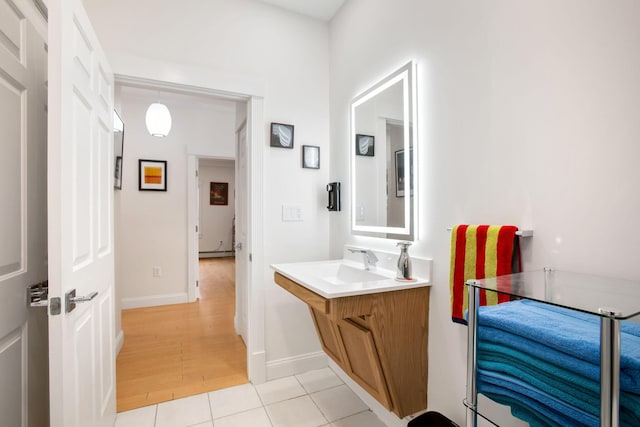 bathroom with vanity, a baseboard radiator, and tile patterned floors