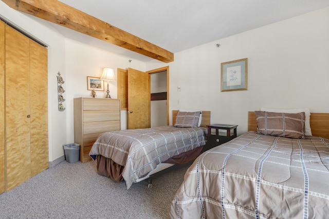 bedroom featuring carpet floors and beamed ceiling