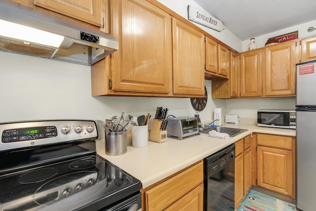 kitchen with sink, a textured ceiling, and appliances with stainless steel finishes