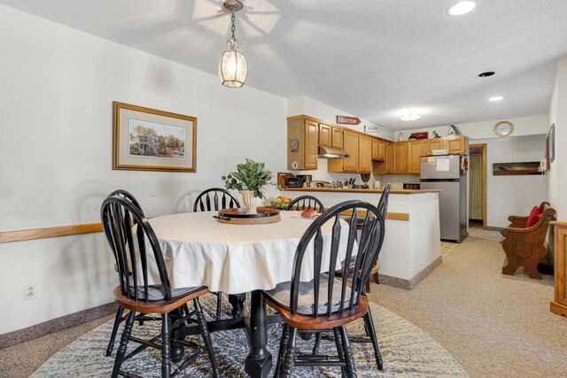 dining area featuring a textured ceiling